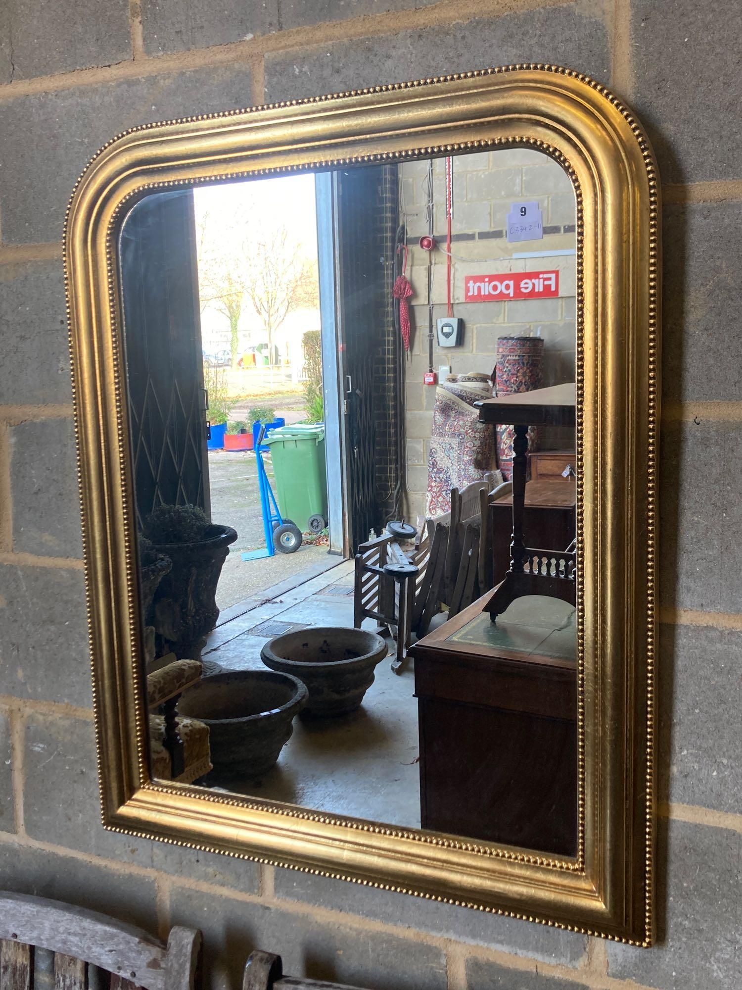 A modern gilt frame arched wall mirror, width 80cm height 100cm